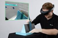 Augmented reality system facilitates manual manufacturing of products made of fiber-reinforced composite materials