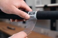 Highly durable self-laminating label for harsh conditions