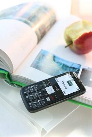 Lifestyle Doro PhoneEasy 332gsm black book and apple portrait.JPG