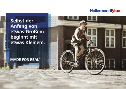 Eine Hommage an die Firmengründung vor über 80 Jahren: Ein HellermannTyton-Junior tritt in die Pedale eines Fahrrads, dessen Ventile Paul Hellermann zu seiner Patenttülle inspirierte.