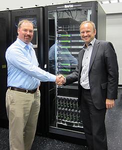 (ltr) Garrett Hill, CEO X2nSat, and Serge Van Herck, CEO Newtec, commemorate their partnership