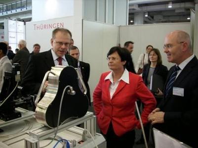 Thuringia"s Minister-President C. Lieberknecht with Dr. D. Weber (μ-GPS, left) and LEG Thuringia‟s Managing Director A. Krey at the μ-GPS booth, Foto: CITY-PRESS, P. Schmalfeldt
