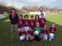 Die Fußballmannschaft E2 Junioren des FC Haunstetten und die beiden Trainer, Werner Mayer (links) sowie Rainer Zöller (rechts), freuen sich über die neuen von CADENAS gesponserten Trikots