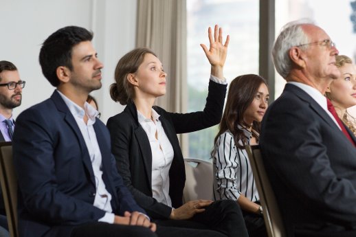 woman-meeting-with-raised-hand.jpg