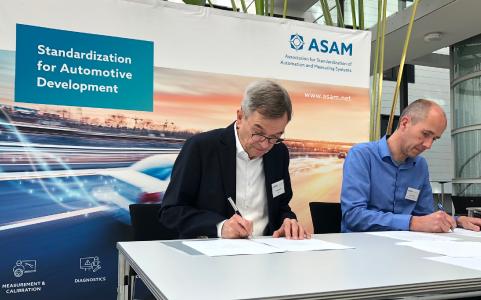 M. Dupuis (VIRES) and Dr. Klaus Estenfeld (ASAM) signing the contract to transfer OpenSCENARIO to ASAM