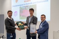 Dr. Eduard Kraus, Division Manager Joining and Surface Technology (left) and Michael Heilig, Group Manager Bonding and Surface Technology (right) present Dr. Martin Rütters from Fraunhofer IFAM with a certificate for the 10th anniversary and a small gift from Franconia.