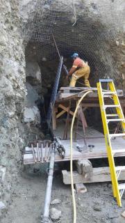 Photo of new screening being placed by Hitachi 180 excavator