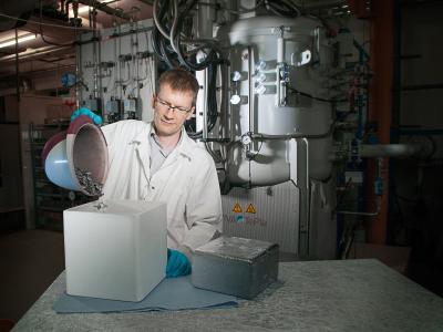 Dr.-Ing. Matthias Trempa, Preisträger des Ulrich-Gösele-Young-Scientist-Awards, beim Befüllen eines Tiegels mit Silizium-Rohstoff. © Fraunhofer IISB