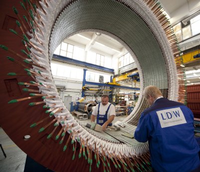 Inserting of copper coils into the stator core for an AC-machine m.jpg