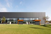 Corten steel shelters in the car park in front of the west façade