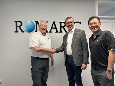 Rory from Romaric shaking hand with Henri from Elisa, with Bryan from camLine standing on the si.jpg