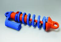 Stoßdämpfer-Modell aus 5 Einzelteilen gedruckt und zusammengefügt - die Feder ist flexibel und kann wie bei einem echten Stoßdämpfer zusammengedrückt werden 