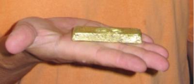Photo 1 An 11 ounce gold bar produced from surface prospecting and trenching on the Rivard property