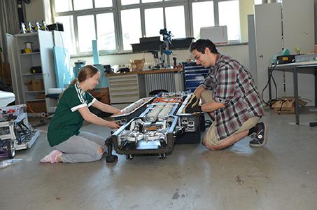 Young engineers assembling the electronics and connectors on the Swissloop Pod