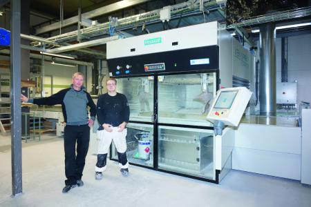 Ven Spray Comfort, Project Manager Andreas Persson and System Operator Tim Hultén in front of the heart of the coating plant—a spray coating machine from Venjakob, Photo: Copyright Venjakob
