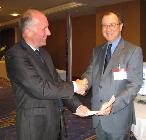 John Verity of ITSO presents the certificate to John Clarkson, Almex UK General Manager.png