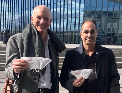 From left: Carlo Centonze, Dr. Thierry Pelet holding the first prototype of HeiQ Viroblock NPJ03 treated face masks (image provided by HeiQ)