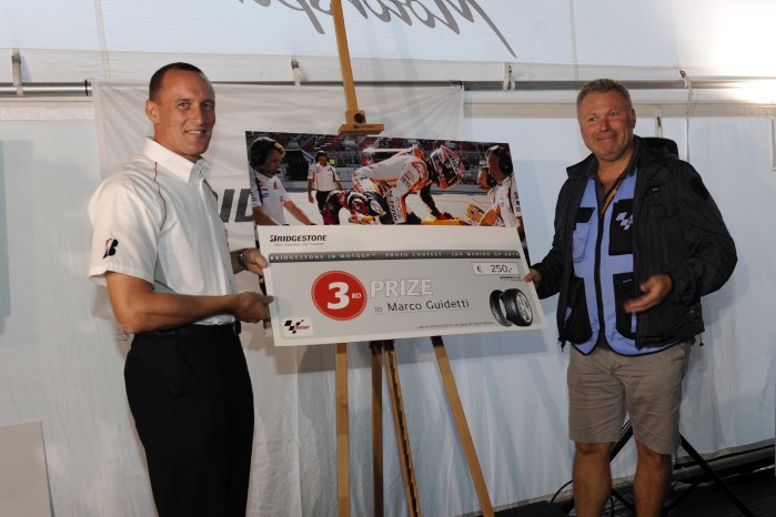Third place photographer Marco Guidetti being presented his prize by Bridgestone Europe South Re.jpg