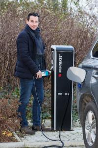 WEMAG-Projektmanager Benjamin Hintz schließt ein Elektroauto an der Ladesäule an, Foto: WEMAG/Stephan Rudolph-Kramer