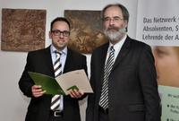Preisträger Markus Schweitzer nimmt seine Auszeichnung im Rahmen der Absolventenfeier von Prof. Dr. Paul Nikodemus, Präsident der AKAD University, entgegen. Foto: AKAD