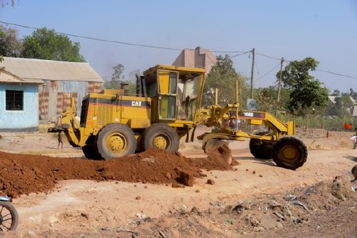 Lake Victoria - A grader shapes quality laterite road material during repairs on the Katoro to I.jpg