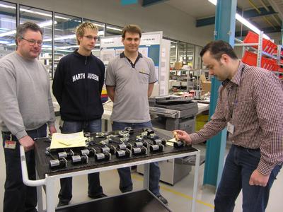 A satisfied assembly team completes the final acceptance of the 1000th flight lock actuator at the WITTENSTEIN aerospace&simulation assembly shop in Igersheim-Harthausen (from right to left): Team Manager Stefan Zang with Daniel Landwehr, Marcus Michel an