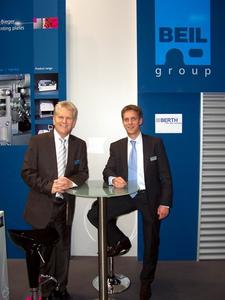 During the drupa exhibition in Duesseldorf, Germany, Günter Beil, President of the BEIL Group (left) and Christoph Thielmann, President of Berth Maschinenbau GmbH & Co. KG (right) agree on a sales co-operation.
