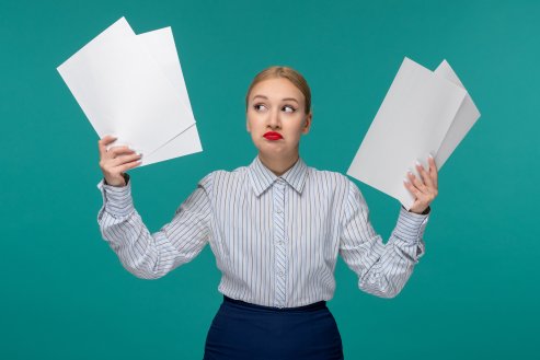 business-lady-confused-cute-pretty-young-girl-office-outfit-holding-paper-sheets.png