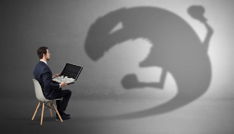 man-with-money-in-case-and-ominous-shadow-1-1030x588.webp