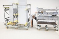 Das Bild zeigt eine mobile Transport- und Kommissionierlösung aus dem modularen Rohrstecksystem von BeeWaTec. Der Wagen ist mit mehreren Ablageebenen ausgestattet und für den flexiblen Materialfluss in Produktion und Logistik konzipiert. Durch die robuste Konstruktion, ergonomische Zugänglichkeit und modulare Bauweise unterstützt er effiziente Kommissionier- und Transportprozesse im Sinne der Lean Production.