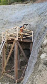 Photo of new screening being placed by Hitachi 180 excavator