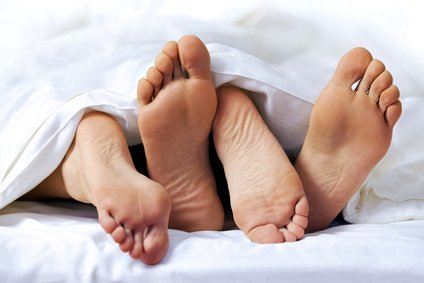 Close-up of the feet of a couple on the bed - togethermedien.net.jpg