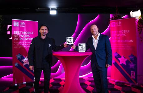umlaut CEO Telecommunication Hakan Ekmen hands over two trophies to T-Mobile Netherlands CEO Søren Abildgaard in The Hague.