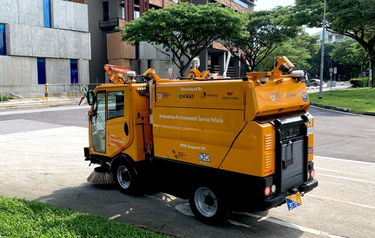 Autonomous road sweeper driving around a curve.jpg