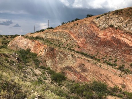 Aztec Minerals - Oxidized-epithermal-gold-silver-mineralization-rusty-areas-within-folded-and-fa.jpg