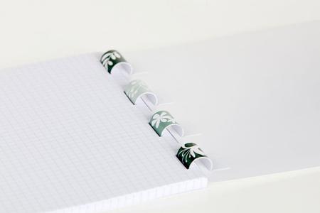 Gluing of the tabs on the spine. The printable paper spiral is also visible when the body of the book is open