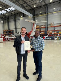 L-R_Michael_Axtmann_receives_the_AMO_certificate_from_Toks_Fadairo.jpg