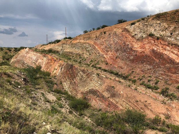 Aztec Minerals - Oxidized-epithermal-gold-silver-mineralization-rusty-areas-within-folded-and-fa.jpg
