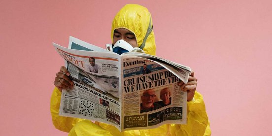 man-in-yellow-protective-suit-holding-a-newspaper-1200x800.jpg