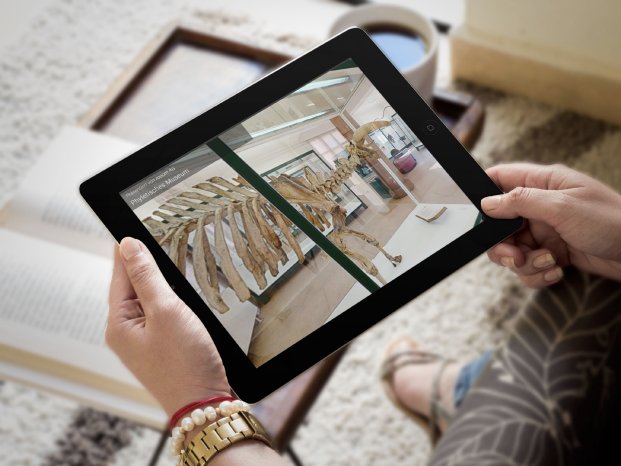 mockup-of-a-black-ipad-being-held-inside-a-living-room.png