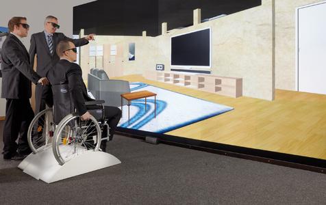 Bei der Lösung VAALIDATE des Fraunhofer IGD setzt sich der Architekt oder Bauherr zunächst eine 3D-Brille auf und dann in einen Rollstuhl. Auf einer hochauflö-senden 3D-Wand kann er mit dem Rollstuhl das Gebäude noch vor dessen Fertigstellung simuliert befahren. VAALI-DATE wird am 16. Mai 2012 im Wettbewerb "Deutschland – Land der Ideen" ausgezeichnet (Foto:Fraunhofer IGD)
