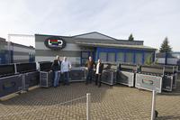 Flight cases specially developed for transporting 100 m2 of TARMLED 4x4 tiles.Standing in front of tarm's Bochum, Germany, headquarters building are, from l. to r., the company's founder, Ralf Lottig, T.Lottig, Sascha Kwasny, and F.Freitag