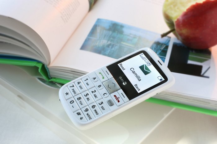 Lifestyle Doro PhoneEasy 332gsm white book and apple landscape.JPG
