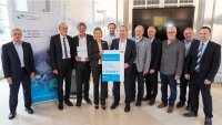 Bavaria's Minister of Economic Affairs Hubert Aiwanger presents a funding approval notice for €1.8 million to the FORnanoSatellites research consortium