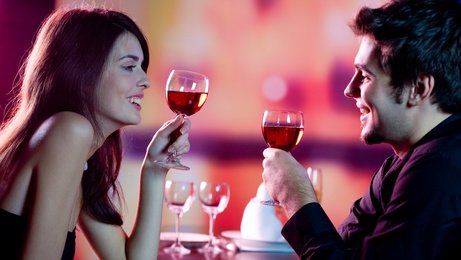 Young couple celebrating with red wine at restaurant - togethermedien.net.jpg