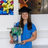 Rebecca Wolff with her printer test stand. (Photo: Philipp Köhler, SKZ)