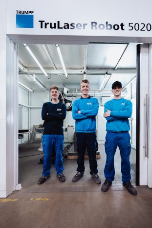 Tobias Melches mit zwei Auszubildenden vor dem Laserschweiß-Roboter_2.jpg
